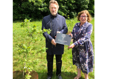 Placing the Queen’s Green Canopy plaque on Croxley Green